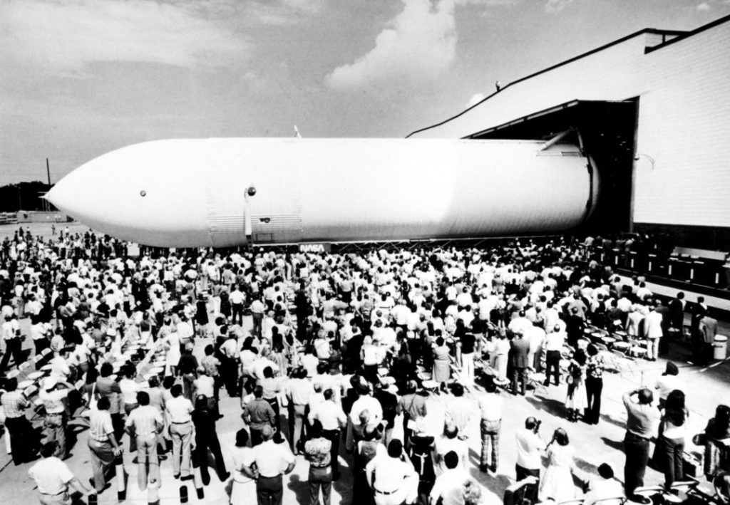 The first Space Shuttle External Tank rolls off the assembly line on September 9, 1977 at the Michoud Assembly Facility in New Orleans. Courtesy of NASA.]