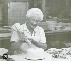 Beulah Ledner, icing a doberge cake, a cake she invented.
